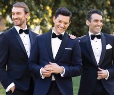 three men in tuxedos are smiling for the camera