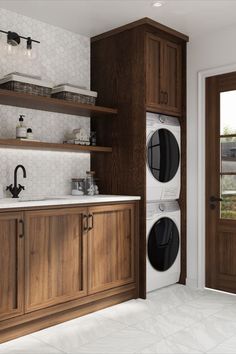 a washer and dryer sitting in a kitchen next to wooden cabinets with open doors