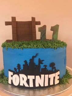 a birthday cake with the name fortnite on it and an image of a city