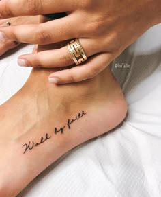 a woman's foot with the words wake me up tattooed on her left side