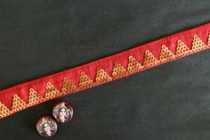 An elegant pretty trim in bold red and gold, to add a dose of glamour to anything it touches. With a triangle pattern created with light gold sequins, which reminds one of the gorgeous pyramids. A colour combination that spells royalty. Use it to embellish your denim jackets, or border your sarees. Or create home décor like lamps or curtain ties. Or accessories like hair bands. One trim, countless possibilities. Price for 1 mtr Size - 3 cm W Note - Colours may look slightly different to you from Red Fitted Saree With Embroidered Border, Fitted Red Saree With Embroidered Border, Festive Red Fabric With Dori Embroidery, Red Lehenga With Gold Embroidery For Wedding, Red Embroidered Fabric With Zari Work For Celebration, Red Zari Work Embroidered Fabric For Celebration, Gold Embroidered Saree Fabric For Ceremonies, Gold Fitted Traditional Wear With Embroidered Border, Fitted Gold Traditional Wear With Embroidered Border