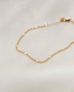 The bracelet that shines like summer incarnate. Each chain is dotted with little sunbursts to catch the light—like fireflies, twinkling lights and golden hour all rolled into one! Style it solo, stack with your favorite bracelets or add a charm for an extra sparkle of personalization. Want to shine even brighter? Check out the full Radiant Collection. Delicate Gold Bracelet With Satellite Chain For Everyday, Everyday Gold Bracelet With Satellite Chain, Adjustable Delicate Gold Bracelet With Chain, Dainty 14k Gold Filled Bracelet, 14k Gold Filled Satellite Chain Bracelet As Gift, Yellow Gold Bracelet With Tiny Beads For Everyday, Dainty Gold Bracelet With Adjustable Chain, Dainty Adjustable Gold Bracelet, Delicate 14k Yellow Gold Filled Bracelets