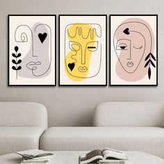 three abstract paintings hang on the wall above a white couch in a modern living room