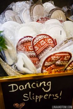 a basket filled with lots of white and red heart shaped cookies next to a sign that says dancing slippers