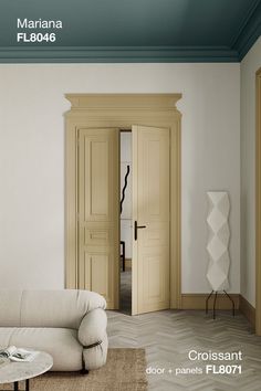 the interior of a living room with white walls and wood trimming on the doors