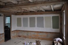 an empty room with unfinished paint on the walls