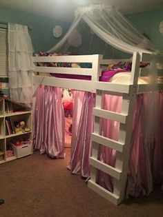 there is a bunk bed with pink curtains on the top and bottom, next to a bookcase