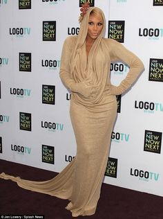 a woman in a long dress posing on the red carpet