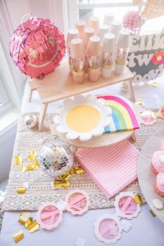 a table topped with cupcakes and candy