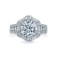 a diamond engagement ring with baguetts on the shoulders and sides, set in 18k white gold