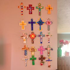 the wall is decorated with colorful crosses on it