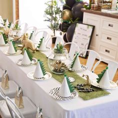 the table is set with white and green decorations