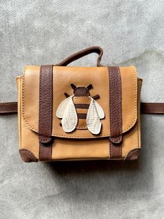 We're suckers for cute. And for serious craftsmanship. So we are truly delighted to offer pieces by the Dutch maker Donsje. Sustainably sourced, fair trade, made by hand and made to last. Darling leather accessories that make everyone smile. Little leather "Bee" fanny pack is 6 x 4 1/2 inches with a belt that adjusts from 22 - 26 inches. Fanny Pack Aesthetic, Bee Bag, Bee Purse, Leather Accessories Handmade, Sweet Accessories, Leather Craft Projects, Leather Bag Pattern, Animal Bag, Sewing Leather