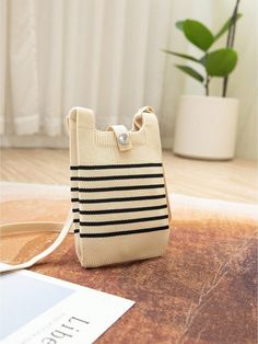 This knitted foldable handbag is both chic and convenient, perfect for daily use and adventures. Its striped design adds a stylish touch, while its foldable feature allows for easy storage and portability. Crafted with durability in mind, it's the ideal bag for all your needs. Color : Beige Magnetic : No Bag Size : Mini Style : Casual, Minimalist Type : Crochet Bags Closure Type : Buckle Strap Type : Double Handle, Top Handle Pattern Type : Striped Features : Lightweight, Foldable Composition : Casual Beige Phone Bag, Casual Beige Phone Bag With Large Capacity, Casual Beige Large Capacity Phone Bag, Casual Foldable Pouch Bag, Casual Foldable Shoulder Bag For Everyday Use, Casual Foldable Shoulder Bag, Casual Everyday Foldable Shoulder Bag, Casual Beige Phone Bag For On-the-go, Crochet Bags