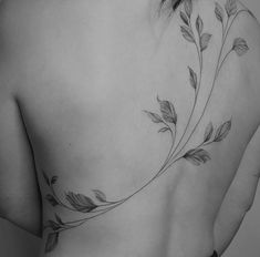 a woman's back with leaves on it