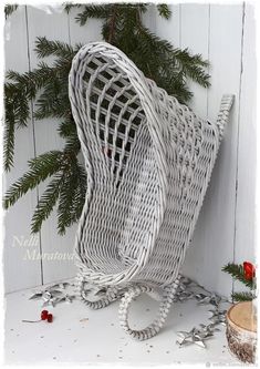 a white wicker chair sitting next to a christmas tree