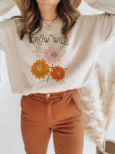 "Grow Wild in a beautiful elegant font with vintage flowers sublimated on a cozy unisex crewneck sweatshirt. These sweatshirts are unisex and true to size. PRODUCTION AND SHIPPING * Processing is 4-6 business days. All of my tees are made to order (WITH LOVE!) by me and shipped out of Erie, PA. * Estimated \"receive by\" dates are estimates only. Once the item is dropped off at the USPS facility, I no longer have control of your package. Therefore, I will not responsible for items delayed by USP Cream Crew Neck Sweatshirt For Spring, Spring Cream Graphic Sweatshirt, Cream Graphic Print Sweatshirt For Spring, Spring Cream Graphic Print Sweatshirt, Vintage Letter Print Sweatshirt For Spring, Fall Cottagecore Crew Neck Sweatshirt, Cottagecore Cotton Crew Neck Sweatshirt, Beige Sweatshirt, Erie Pa