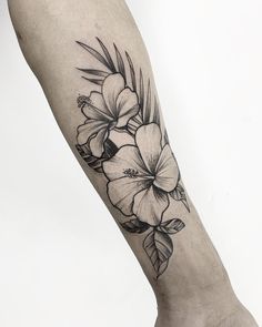 a black and white flower tattoo on the leg