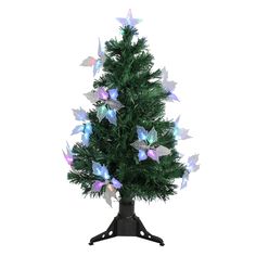 a small christmas tree with purple and blue butterflies on it's top, in a black metal stand