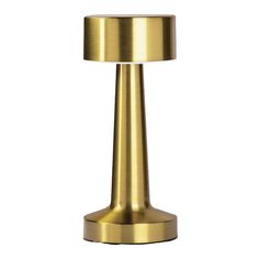 a brass colored table lamp on a white background