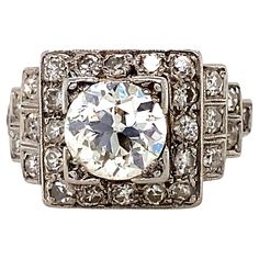 Hailing from the roaring twenties, this stunning original platinum, circa 1920s-30s, Art Deco engagement ring features diamond pave-set steps leading to a scintillating 1.32 carat center old European-cut diamond; the ring is accented with single-cut and old European single-cut diamonds weighing 0.75 carat total giving the ring a total diamond weight of 2.07 carat. The center old European-cut diamond is L color grade and VS2 clarity grade. This amazing Jazz Age ring is impressive on the finger an Daisy Buchanan, Jay Gatsby, The Roaring Twenties, Contemporary Engagement Rings, Platinum Engagement Ring, Engagement Rings Vintage Halo, Platinum Diamond Engagement Rings, Art Deco Diamond Rings, Engagement Ring Diamond Cut