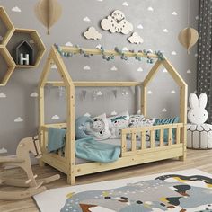 a child's bedroom with a wooden bed and toy animals on the rugs