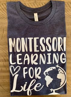 Montessori Learning For Life We have access to many more shirt styles and colors so please send us a message if you do not see what you want need! T-shirt info: -Lettering is done in commercial grade heat transfer vinyl and heat pressed on -Tee is a super soft poly/cotton blend for heather colors and 100% cotton for non heather colors. -Please specify black or white vinyl for the lettering and design in the notes section or we will choose for you which typically means white vinyl for dark shirts and black vinyl for light colored shirts. -This tee comes in adult unisex sizing. To get a comfortable loose fit order your regular size. For a more fitted look order a size down.   *Actual colors and design positioning may vary slightly *Wash inside out on gentle setting and tumble dry on low.  DO Casual Tops With Custom Text For School, Casual T-shirt With Custom Text For School, Casual School Tops With Custom Text, School Cotton Tops With Custom Text, Casual Tops With Text Print For Teaching, Black Vinyl, White Vinyl, Heat Transfer Vinyl, Teacher Shirts