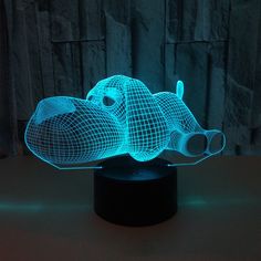 a light that is shaped like a fish on top of a wooden table in the dark