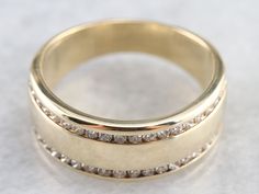 two gold wedding bands with diamonds on them