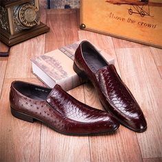 Elevate your style game with our ExoticLuxe Croc Texture Leather Slip-On Oxford Brogues. Crafted with the finest attention to detail, these brogue shoes exude sophistication and elegance, making a statement wherever you go. Featuring a solid pattern and a square toe shape, these timeless shoes are perfect for both formal and casual occasions. Slip them on with ease and experience the luxury and unmatched comfort that sets these brogues apart from the rest. Upgrade your footwear collection today and add a touch of sophistication to your everyday look. Elegant Slip-on Oxfords With Red Sole, Business Loafers With Red Sole And Pointed Toe, Red Brogue Dress Shoes For Office, Elegant Red Wingtip Loafers, Elegant Burgundy Leather Slip-on Shoes, Elegant Burgundy Slip-on Leather Shoes, Red Dress Shoes For Business In Fall, Elegant Burgundy Dress Shoes With Brogue Detailing, Red Formal Dress Shoes For Fall