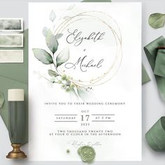 an elegant wedding card with greenery on it