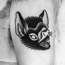 a black and white photo of a cat's head on the thigh with an evil look