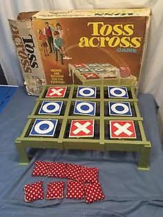 the game toss across is set up on top of a blue table with red and white polka