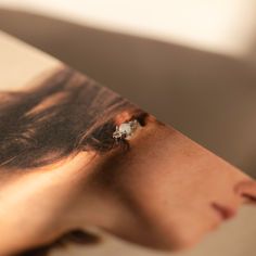 a woman's face is shown through the pages of a book with her eyes closed