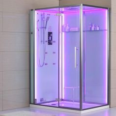 a bathroom with a purple light in the shower