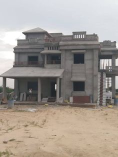 a large gray building sitting on top of a sandy beach