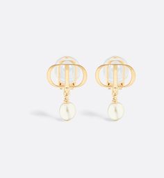 The Petit CD earrings are a work of elegance and refinement, available this season as clip-ons. The style is distinguished by a white resin pearl hanging from a gold-finish metal CD signature. The earrings can be styled with other Petit CD creations for a modern and sophisticated look.. Designer Gold Drop Pearl Earrings, Designer Gold Pearl Drop Earrings, Designer Gold-tone Clip-on Earrings, Luxury White Drop Clip-on Earrings, Luxury White Clip-on Drop Earrings, Cd Earrings, Resin Pearl, Dior Jewelry, Gold Finish