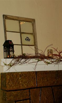 an old window frame sitting on top of a mantle