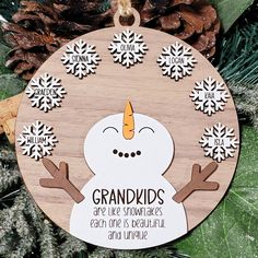 a wooden ornament with an image of a snowman in the center and words grandkids are like snowflakes each one is beautiful and unique