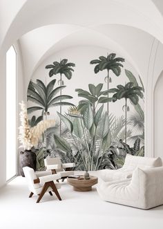 a living room filled with white furniture and wallpaper covered in tropical plants on the walls