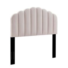 an upholstered headboard with black legs