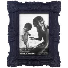 a black and white photo frame with an image of a woman holding a child's hand