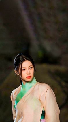 a woman in a kimono is posing for the camera