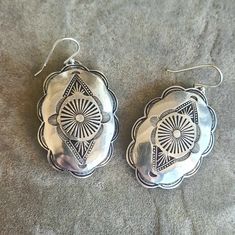 A large pair of shiny solid sterling silver concho  earrings, handmade, stamped and then slightly domed by me here in beea-utiful Tucson, Arizona. They're cut from hefty 20 gauge sterling sheet and weigh approximately 13.5 grams for the pair. Conchos measure 1 1/2" in length by 1 1/4" wide. With the earwire, they're approximately 2" long - and will definitely get you noticed! Nice and deeply stamped for surface texture using vintage navajo-style stamps, these earrings will last a lifetime - a tr Cheap Silver Concho Earrings, Nickel Free Silver Southwestern Earrings, Southwestern Silver Earrings For Gifts, Silver Southwestern Style Earrings For Gifting, Silver Southwestern Style Earrings For Gift, Silver Southwestern Earrings For Gift, Artisan Stamped 925 Earrings, Bohemian Sterling Silver Oval Earrings, Bohemian Oval Sterling Silver Earrings