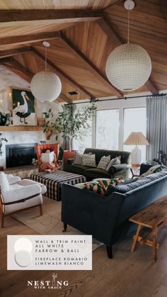 a living room filled with lots of furniture next to a fire place and large windows