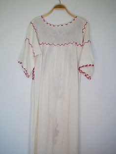 "Beautiful Antique 0ff-White Cotton Gauze Maxi Dress with Floral Hand Embroidery . Features hand embroidered flowers on chest front, neck and sleeves. Half Sleeve drawstring at cuff sleeves. Condition: Good Vintage Condition. ** black spot on hip area and missing embroidered detail on skirt. \"shown in the detailing picture \" BEST FIT = M Please be sure to check the measurements to insure a perfect fit. Details and Measurements (Inch) BUST: 38 \" HIPS: 50 \" FULL LENGTH: 52 \" SLEEVE LENGTH: 11 Traditional Cream Dress With Chikankari Embroidery, Traditional Cream Chikankari Embroidered Dress, Festive Off-white Dress With Floral Embroidery, Festive Off-white Floral Embroidered Dress, Festive Off White Floral Embroidery Dress, Off White Cotton Dress With Resham Embroidery, Festive White Dress With Embroidered Border, Traditional Long White Dress, Red Chikankari Embroidery Summer Dress