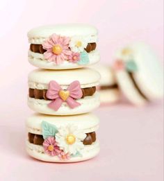 four cookies decorated with flowers and chocolates are stacked on top of eachother