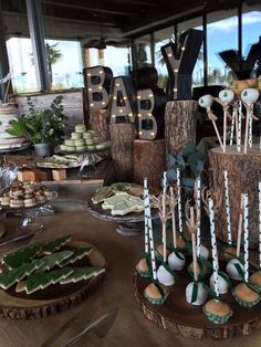 an assortment of desserts on display at a baby shower