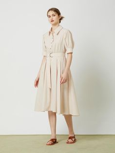 This belted flared long dress exudes a feminine and elegant style with its flared silhouette, shirring at the waist, and voluminous sleeves.- Long length that makes your outfit stylish- A-line silhouette to add appeal to the item- D-ring belt detail for added interest* The color of the actual product may vary due to differences in monitor color settings and resolution. Elegant Beige Midi Dress With Pleated Waist, Elegant Spring Shirt Dress With Belted Cuffs, Beige A-line Midi Dress With Pleated Waist, Spring Beige Dresses With Belted Cuffs, Beige Spring Dresses With Belted Cuffs, Elegant Midi Shirt Dress With Pleated Sleeves, Spring Beige Dress With Belted Cuffs, Beige Spring Dress With Belted Cuffs, Beige Dress With Belted Cuffs For Spring