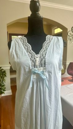 A lovely lightweight nightgown in the palest of blue.  This vintage Laura Ashley nightgown has a lace trimmed v-neckline with a decorative blue satin bow at the bust line.  In good vintage condition with no rips or stains.  Made in India. The bust measures 19 inches from armpit to armpit laying flat, 48 inches from shoulder to hem. Please examine the pics, feel free to ask questions. Summer V-neck Nightgown With Delicate Lace, Summer Nightgown With Delicate Lace For Bedtime, Summer Delicate Lace Nightgown For Bedtime, Summer Delicate Lace Nightgown, Summer Sleeveless Nightgown With Delicate Lace, Summer Nightgown With Delicate Lace For Loungewear, Summer Sleeveless Delicate Lace Nightgown, Summer Delicate Lace Nightgown For Loungewear, Sleeveless Delicate Lace Summer Nightgown